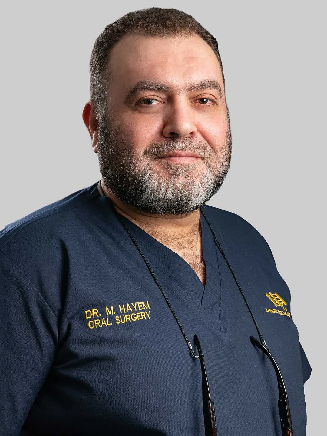 Dr. Mohammad Hayem Zin Alabdin wearing his oral surgery scrubs